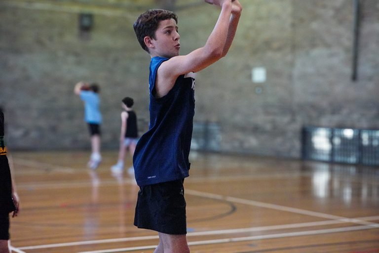 A boys practicing on the Basketball Training session